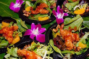 small plates of crispy chicken on greens by orchids